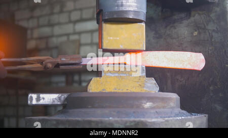 Automatische hämmern - schmied Schmieden rote heiße Eisen auf dem Amboss, extreme Close-up Stockfoto