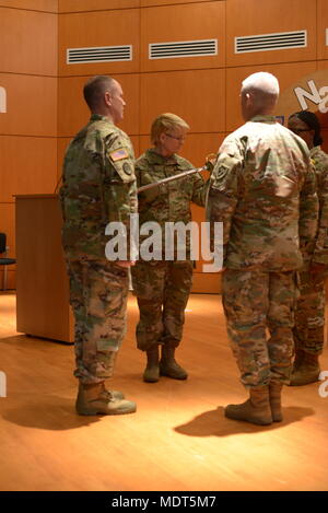 Command Sgt. Maj. Diana Staton, die eingehenden senior Soldaten leader (SEL) für 60 Truppe den Befehl, inspiziert ein noncommissioned officer Schwert, nachdem er bei einem Wechsel der Verantwortung Zeremonie an der gemeinsamen Kraft von North Carolina National Guard Hauptsitz in Raleigh, North Carolina, Dez. 2, 2017 ihr übergeben wurde. Die Verabschiedung des Schwert von den ausgehenden SEL für den Commander und dann an die eingehenden SEL bedeutet den Übergang der Verantwortung von Soldaten der Organisation aus der früheren Soldaten leader, die eingehenden. (U.S. Army National Guard Foto: Staff Sgt. Maria Junell, 382 Öffentliche Af Stockfoto