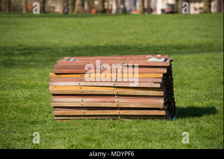 20. April 2018. Warmes Wetter im Frühling im Green Park mit Stack von Liegestühlen, London, UK Stockfoto