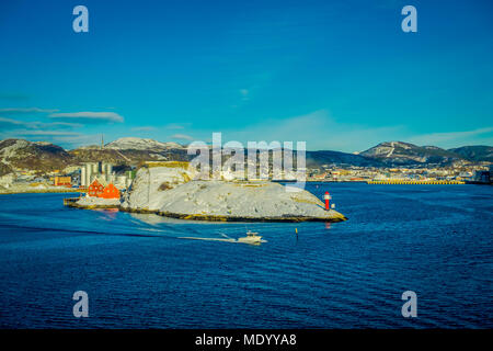 Bodo, Norwegen - 09 April, 2018: Im freien Blick auf die Landschaft von einem Leuchtturm an der Küste von Bodo und einige Gebäude, mit einem wunderschönen blauen Himmel in Norwegen Stockfoto