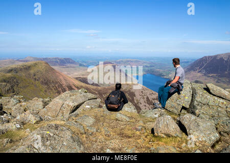 Lake District, Cumbria, Samstag, 21. April 2018. UK Wetter. Blauen Himmel und warmen Sonnenschein, sofern diese Wanderer im Lake District mit spektakulärer Aussicht auf die Berge von Red Pike und hohen Stil über Crummock Water in Richtung Westküste. David Forster/Alamy Live Stockfoto