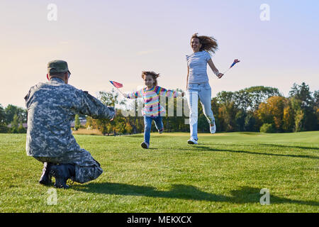 Frau und Tochter sind Treffen Soldat in Uniform. Stockfoto