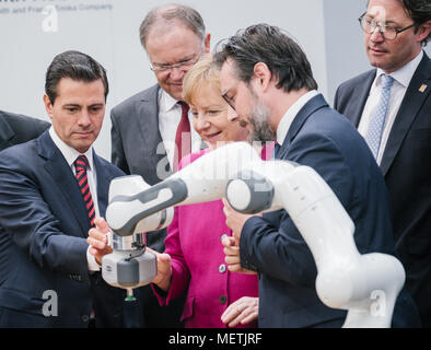 Hannover, Deutschland. 23 April 2018, Deutschland, Hannover: Die deutsche Bundeskanzlerin Angela Merkel, der Christlich Demokratischen Union (CDU, C) und Enrique Peña Nieto, Präsident der Partner Land Mexiko (L), betreiben ein Roboter an der Franka Emika Stand auf der Hannover Messe 2018 (lit. Hannover Messe 2018). Stephan Weil der Sozialdemokratischen Partei (SPD, L) und Andreas Scheuer der Christlich Sozialen Union (CSU), Bundesminister für Verkehr und digitale Infrastruktur, stehen im Hintergrund. Sami Haddadin des Instituts für Regelungstechnik der Leibniz Universität Hannover steht auf der rechten Seite. Foto: O Stockfoto