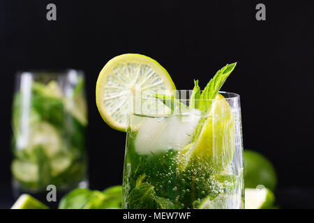 Mojito Cocktail mit mit Garnierung in Glas auf Schwarz. Low Key Foto. Close Up. Kopieren Sie Platz. Stockfoto