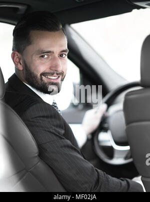 Unternehmer sitzen am Steuer eines Autos, und wenn man die Kamera Stockfoto