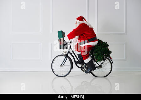Santa Claus reiten Fahrrad Stockfoto