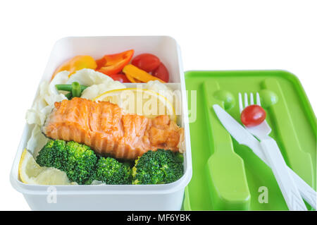 Grüne Schule Lunch Box mit einem Stück Lachs auf ein Paar, Brokkoli Blumenkohl, Paprika und Tomate Bohnen und Zitrone closeup auf Licht Schiefertafel backgro Stockfoto