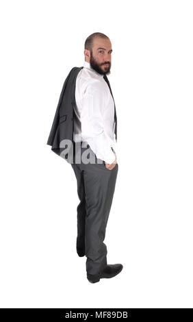 Ein junger hübscher business Mann in Profil und Suchen über seine Schulter, mit seine Jacke über die Schulter, über Weiß isoliert Stockfoto