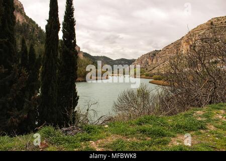 Tolosa Behälter durch die Vegetation und die Berge in Alcala del Jucar Dorf umgeben, Albacete, Spanien Stockfoto