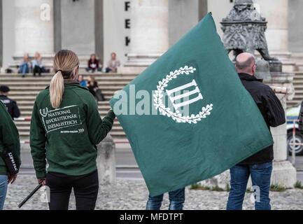 München, Bayern, Deutschland. 25 Apr, 2018. Die militante, extremistischen Neonazis III. Weg (å Weg, dritte Pfad) hielt ihre jährliche Memorial für Reinhold Elstner, ein neo-nazi, die durch Selbstverbrennung 1995 starb. In Anwesenheit war Terrorist Karl-Heinz Statzberger, die für den Versuch der Münchner Synagoge Bombe überführt wurde. Die Gruppe hält diese Zeremonie jährlich auf Max Joseph Platz, vor dem Staatsopera und berühmten Residenz, die Fahnen, die in Opposition zur Gruppe hängen. Credit: Sachelle Babbar/ZUMA Draht/Alamy leben Nachrichten Stockfoto