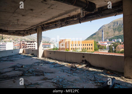 Blick auf den United World College von einem zerbombten Gebäude aus dem Bosnischen Krieg in Mostar, Bosnien und Herzegowina Stockfoto