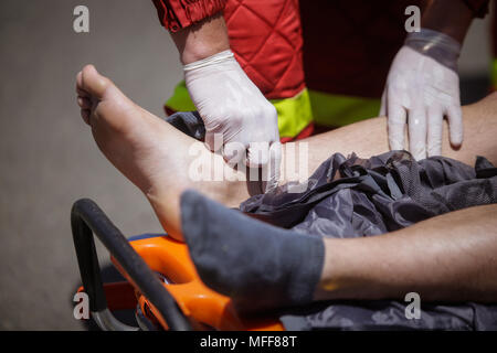 Rescue Feuerwehrleute und Sanitäter nehmen an einem aus verunfallten Fahrzeugen an einen Bohrer Car Crash Site Stockfoto