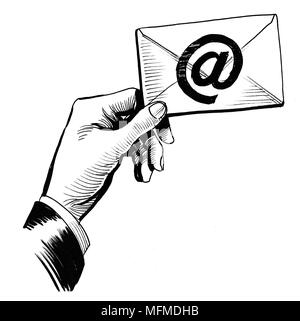 Hand hält sie einen Umschlag mit @ Zeichen Stockfoto
