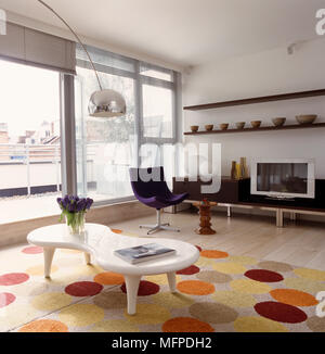 Designer Möbel im Wohnzimmer, ein Eames Nussbaum Hocker, Minotti Stuhl, Marc Newson Couchtisch eine Christine Van Der Hurd Polka Dot Teppich Stockfoto