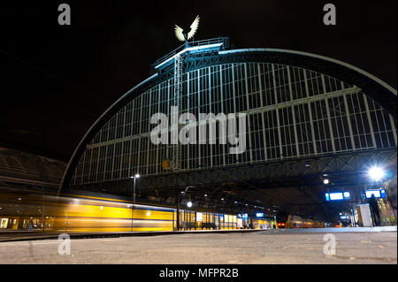 Der Hauptbahnhof von Amsterdam bei Nacht. Zug ist an den Bahnhof. Langzeitbelichtung Nacht Foto. Stockfoto