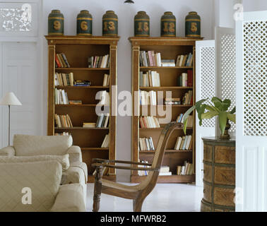 Holz Stuhl und Sessel vor bücherregale Stockfoto