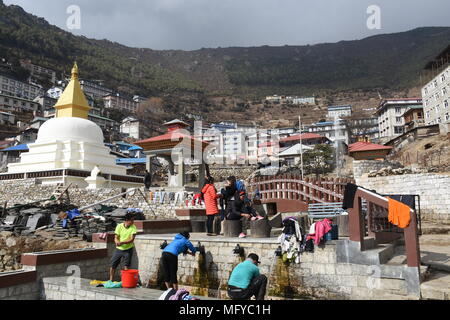 Namche Bazar, Nepal - März 10, 2018: Die Menschen waschen in einem Nebenfluß Stockfoto