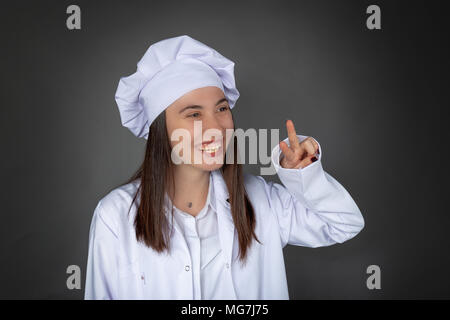 Schöne türkische Koch mit Sieg Zeichen posing Stockfoto