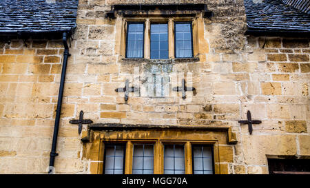 Cotswold Kalkstein wird durch vier Platten auf die Fassade dieses Cottage in der High Street von Chipping Campden gehalten Stockfoto