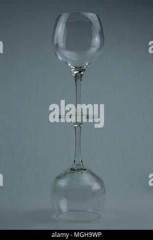 Leer Wein Glas Spiegel effekt, auf grauem Hintergrund Stockfoto