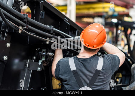 Industrielle Arbeiter versammelt landwirtschaftliche Geräte Stockfoto