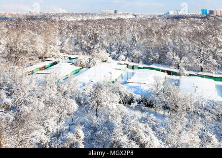 Luftaufnahme von schneebedeckten Garagen zwischen städtischen Timiryazevsky Park und Apple Orchard in Koptevo Bezirk der Stadt Moskau im sonnigen Wintertag Stockfoto