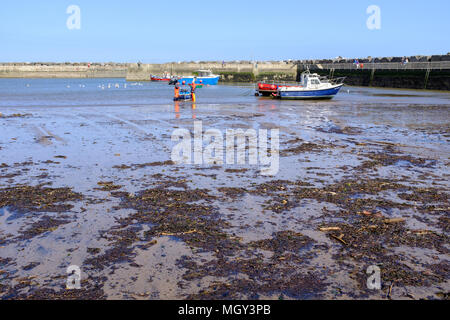 STAITHES, ENGLAND - 21. April: Staithes Fischer im Meer stehen. In Staithes, England. April 2018 21. Stockfoto