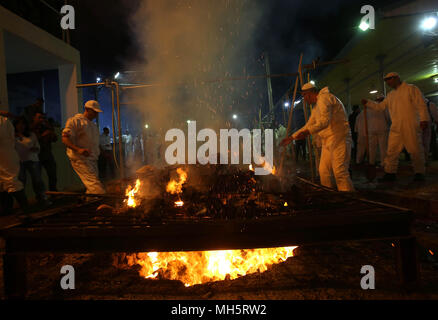 Mitglieder der Samariter Gemeinschaft cook Passahlämmer innere lodernde Feuer Gruben das Passah schlachten (korban Pesakh) Ritual, auf dem Berg Garizim in der Nähe der Stadt Nablus im Westjordanland, 29. April 2018 zu markieren. Die Samariter, ein ethnoreligious Gruppe des Levant aus der Israeliten oder Hebräer, des Alten Orients, Claim Abstieg vom Stamm Ephraim und Stamm Manasse (zwei Söhne von Joseph). Nach der Thora, das Passah schlachten erste war in der Nacht von den Israeliten Exodus aus Ägypten angeboten. Foto: Ayman Nobani/dpa Stockfoto