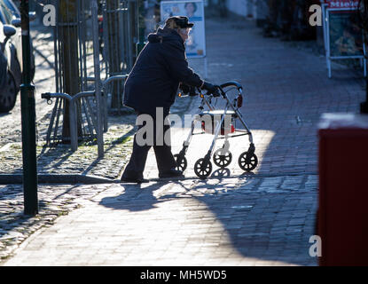 Hagenow, Deutschland. 08 Jan, 2018. 06. Januar 2018, Deutschland, Hagenow: Eine ältere Dame geht mit Ihrer Gehhilfe auf einer menschenleeren Einkaufsstraße mit leeren Geschäften. Credit: Jens Büttner/dpa-Zentralbild/ZB/dpa/Alamy leben Nachrichten Stockfoto