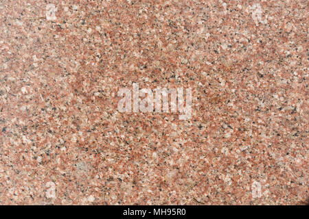 Red Granitplatte mit schwarzen Flecken, Hintergrund. Küche Wand oder Bad Stockfoto