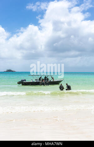 Taucher zu Fuß am Strand auf den Seychellen. Stockfoto