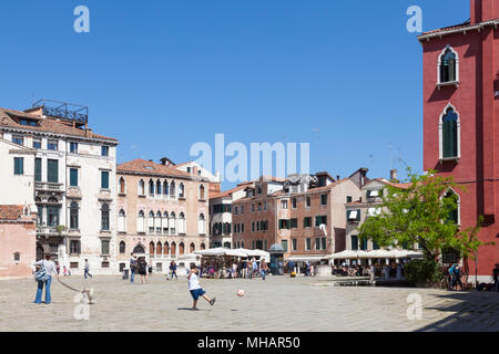 Junge treten eine Kugel in Campo Sant'Anzolo San Marco, Venedig, Venetien, Italien. Venezianischen Alltagsleben. Stockfoto