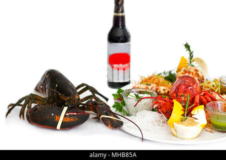 Hummer serviert mit Gemüse auf einem weißen Teller. Isoliert Stockfoto