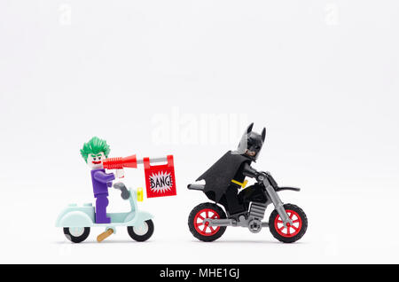 Mini Abbildung von joker reiten Roller mit bang Pistole jagt Batman mit Dirt Bike. Lego Minifiguren sind von der Lego Gruppe hergestellt. Stockfoto