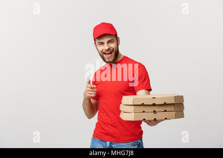 Lieferung Konzept: Stattlichen kaukasischen Pizza Delivery Man Zeigefinger. Über grauer Hintergrund isoliert. Stockfoto