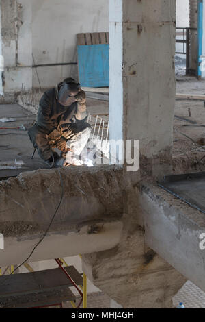 Der schweisser hinter Arbeiten in der alten Gebäude Stockfoto