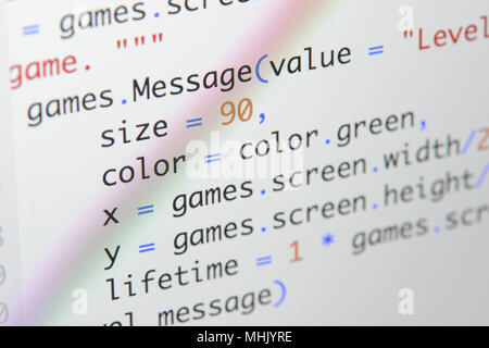 Real Python Code entwickeln. Programmierung Workflow abstrakter Algorithmus Konzept. Linien von Python Code sichtbar unter der Lupe. Stockfoto