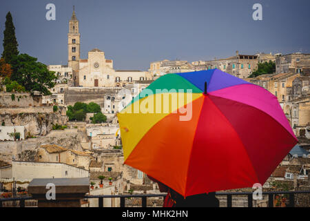 Matera (Italien), September 2017. Touristen mit einem Regenbogen Regenschirm im Belvedere über die antike Stadt namens der Assi di Matera". Querformat. Stockfoto