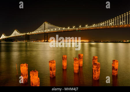 Bay Bridge bei Nacht - eine Nacht Blick auf San Francisco, Oakland Bay Bridge spanning über ruhige Bucht von San Francisco, Kalifornien, USA. Stockfoto