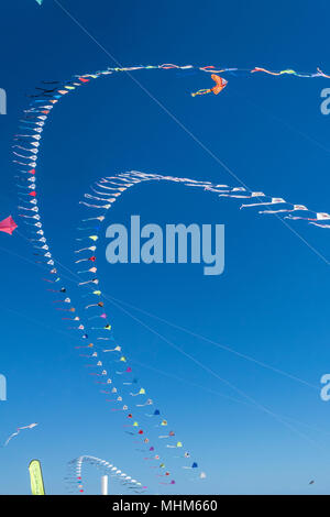 Kite Wettbewerb auf einem sonnigen, heissen Tag. Bunte, kreative Kites fliegen gegen den tiefblauen Himmel in der Karibik Stockfoto
