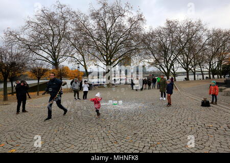 Touristen, Seifenblasen auf der Bank der Rhein bei Köln, Northhine-Westfalia, Deutschland. Stockfoto