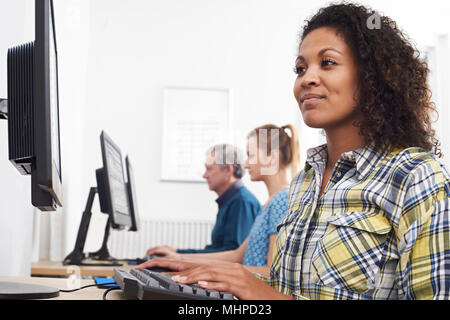 Junge Frau an Computer Klasse Stockfoto