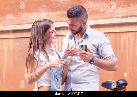 Junges Paar in Liebe tauscht Informationen mit smart phone Stockfoto