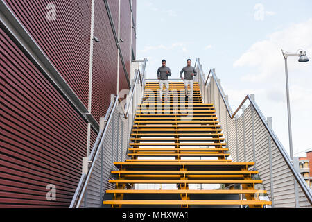 Junge Erwachsene männliche Zwillinge zusammen laufen, Stadt Treppe Stockfoto