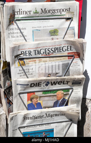 BERLIN - 28.April 2018: Kiosk mit verschiedenen deutschen Zeitungen und Angela Merkel und Donald Trump auf der Titelseite der Tageszeitung die Welt sterben. Stockfoto