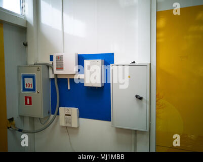 Mehrere Schalttafeln und Alarm System an der Wand des Büros. Stockfoto