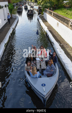 London, Großbritannien. 4. Mai 2018. Die Menschen genießen eine Bootsfahrt wave in Little Venice, West London vor dem 36. Canalway Kavalkade, die läuft von 5. bis 7. Mai Wochenende. Das Festival feiert die britische Binnenwasserstraßen und die Boote, die diese verwenden. Über das lange Wochenende erwartet die Besucher eine Vielzahl von Aktivitäten und Unterhaltung. Credit: Stephen Chung/Alamy leben Nachrichten Stockfoto