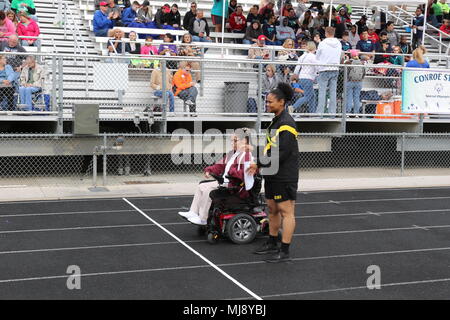 Armee Finden 1. Lt Desiree Randle Freiwillige mit ein Athlet während der Special Olympics Texas Frühling Spiele in College Station, Texas, 21. April 2018. Special Olympics Texas ist Teil der Special Olympics ist die weltweit größte Sportorganisation für Kinder und Erwachsene mit Behinderungen, bietet das ganze Jahr über lokale und regionale Wettbewerbe. (Armee Foto von Sgt. Rigo Cisneros/Freigegeben) Stockfoto