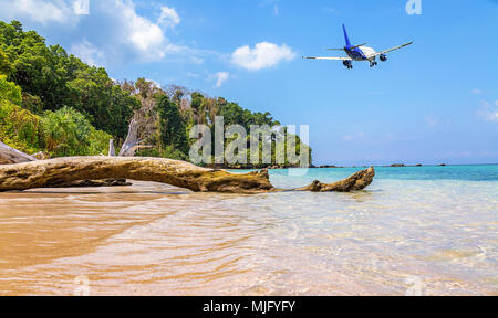 Pkw Flugzeug fliegt tief über malerische Jolly Buoy Insel Meer Strand im Andaman, Indien. Stockfoto