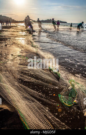 Fischer am Strand Baybay Fisch mit einem seine Netz in frühen Abend Roxas City, Panay Island, Philippinen. Stockfoto